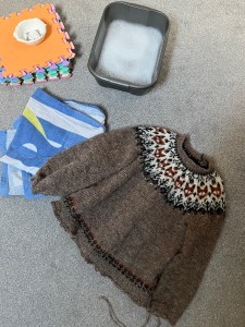 All items needed for blocking assembled: Blocking mats, T pins, basic of soapy water, towel and wool sweater