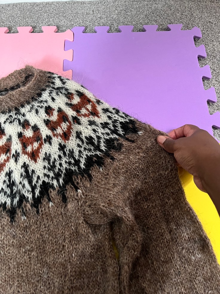 Stretching out damp sweater onto blocking mats