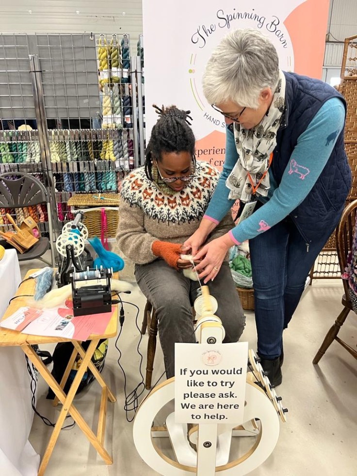 Me trying my hand at spinning wool.