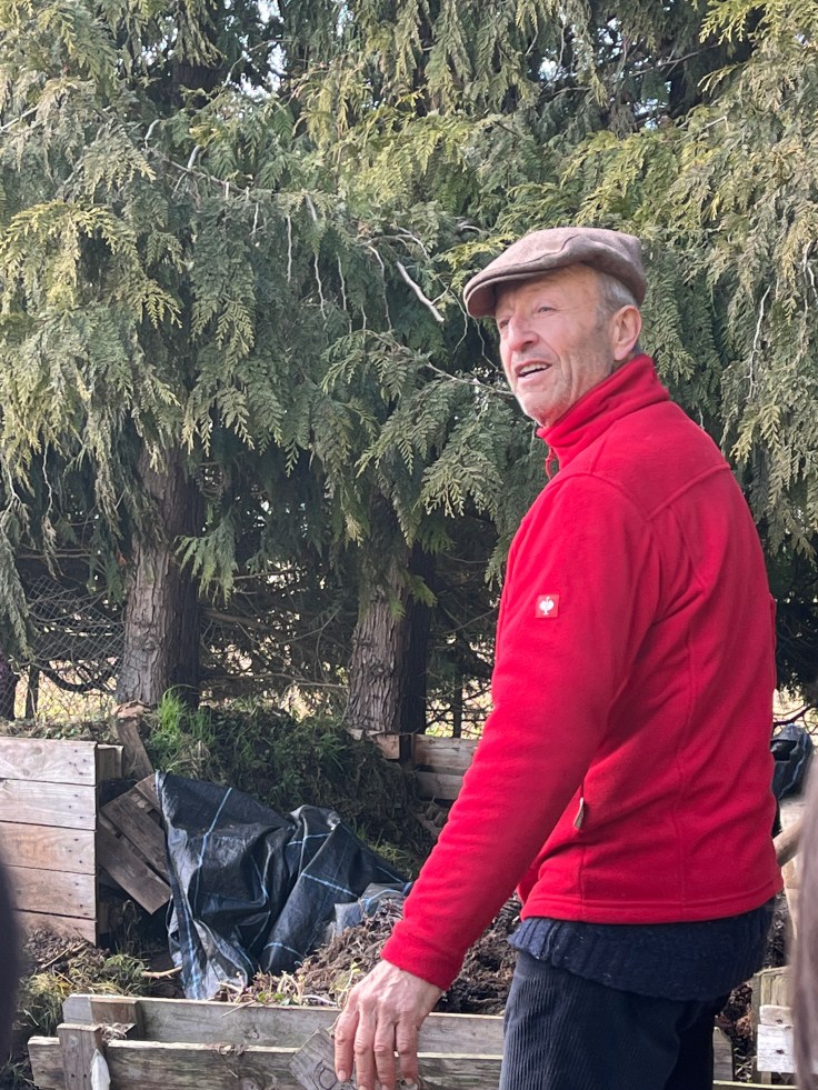 Charles Dowding inspecting the farm compost heap